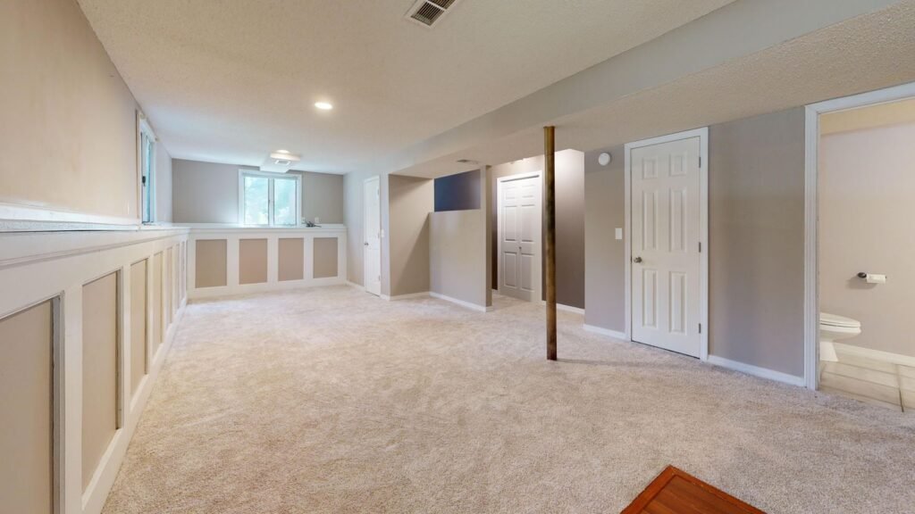 Finished basement development with carpet and recessed lighting