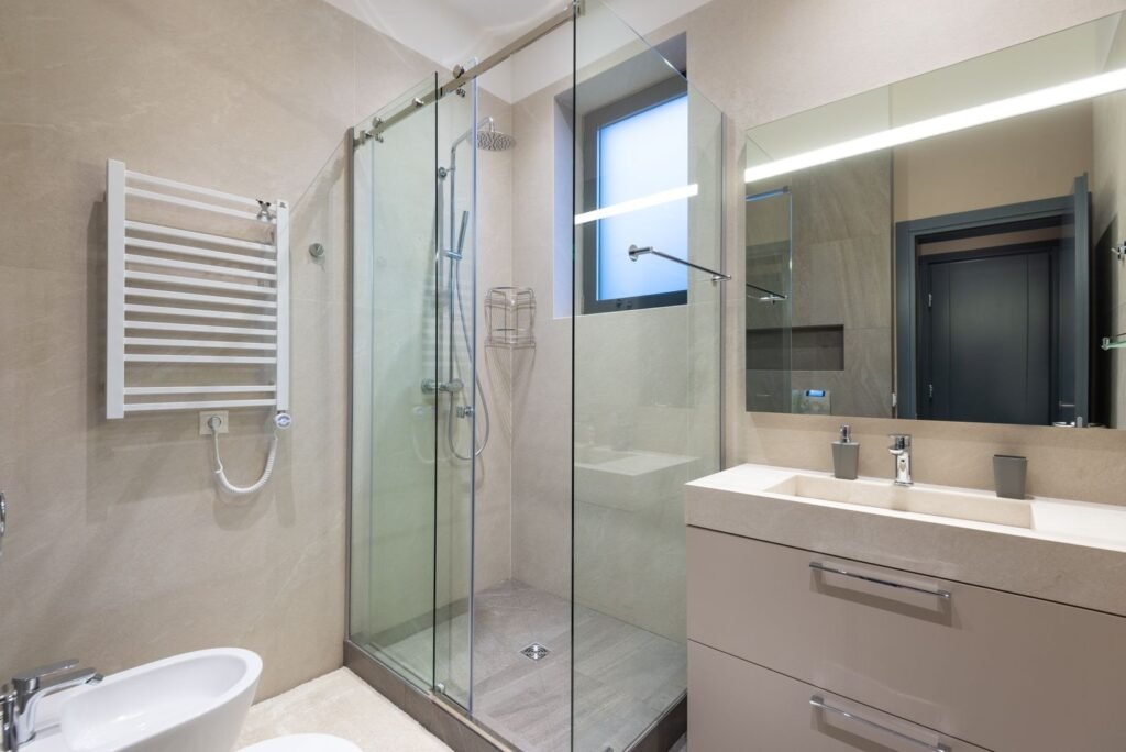 Modern bathroom renovation with glass shower and floating vanity